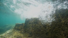 Old stone stairs under water. Waves fall into the water. Beautiful view. 
The camera goes under water. Video recorded in slow motion. 