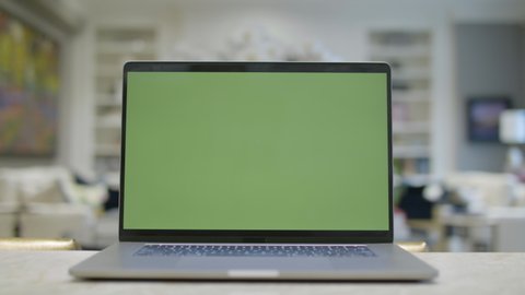 Home office. Green screen laptop computer sitting on a kitchen island. Footage shot with RED, available in 4K and HD. Download the preview for free.
