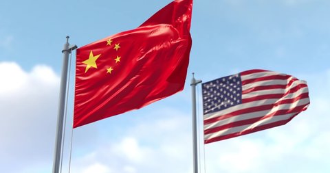 China and USA flag on flagpole. China and The United States of America waving flag in wind. China and US Trade War. US flag in the foreground see on my profile.