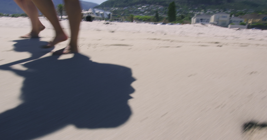 MS TU LA Two brunette women dancing on beach / Cape Town, South Africa