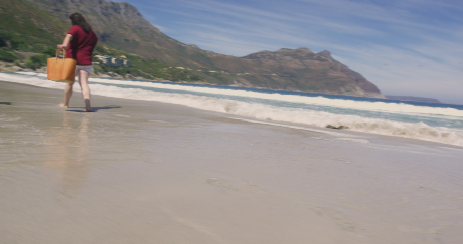 WS TS Two brunette women walking barefoot on sandy beach / Cape Town, South Africa