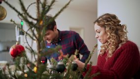 Young couple decorating christmas tree - Powered by Shutterstock - Get 15% off with code: PIKWIZARD15
