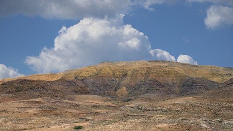 Desert mountain landscape against the background of moving clouds, Jordan, Middle East