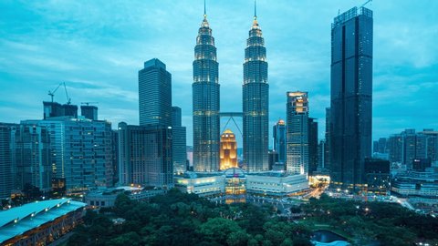 Kuala Lumpur / Malaysia - January 13, 2018 : Kuala Lumpur cityscape. Panoramic view of Petronas Twin Towers and Kuala Lumpur city skyline at sunset and twilight . 4K time-lapse