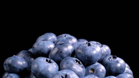 Blueberry background. Filling the screen with a large ripe blueberries. Macro trucking shot. Close up of blueberries. Top view. Slowly panning across fresh Blueberries.