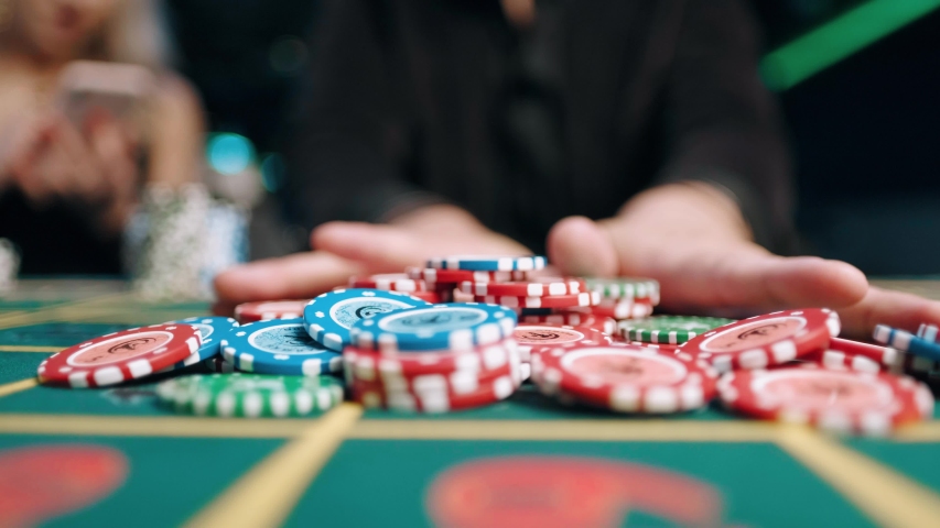 Risky man betting all chips in while playing in casino Royalty-Free Stock Footage #1056384761