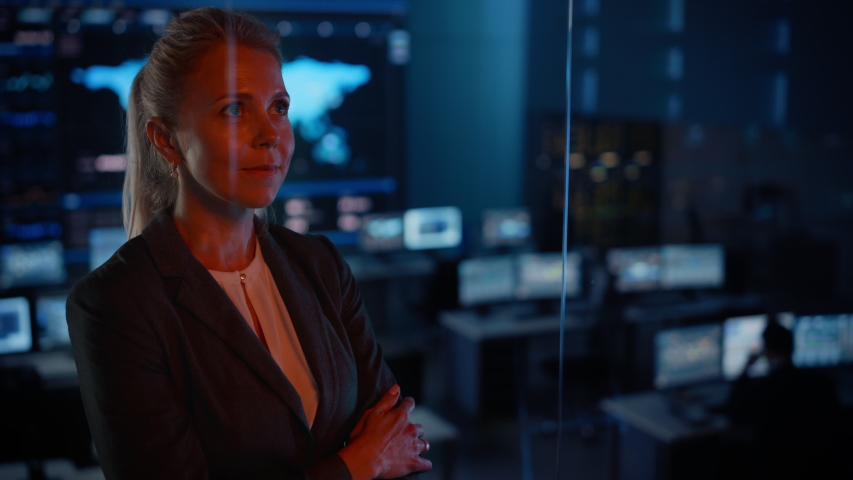 Emotional Female Flight Controller Being Nervous Before a Very Important Space Rocket Launch. Beautiful Portrait with a Reflection in a Mission Control Center. Computer Screens in the Background.