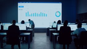 Professional Financial Data Analysts Working in a Modern Monitoring Office with Live Analytics Feed on a Big Digital Screen. Monitoring Room with Finance Specialists Sit in Front of Computers.  - Powered by Shutterstock - Get 15% off with code: PIKWIZARD15