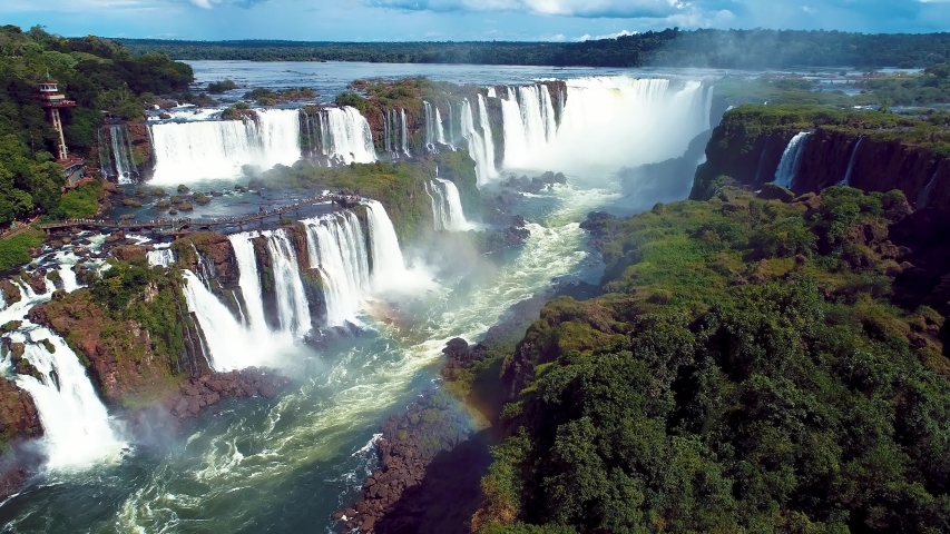 Summer travel. Aerial landscape of giant waterfalls with beauty rainbow. Panorama view of famous Iguacu Falls. Vacation travel.Tropical travel. Travel destination. Summer leisure scene. Parana, Brazil Royalty-Free Stock Footage #1056389213