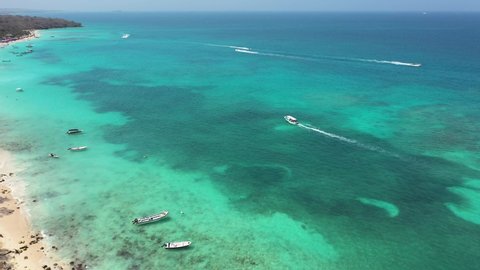Paradise white sand beach, boats floating in the perfectly clear seawater Cartagena Colombia aerial view.