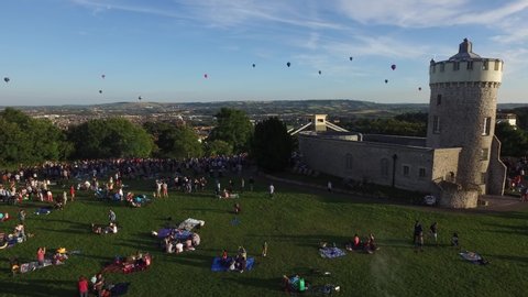 Bristol, England - August 10th 2018: Aerial drone shot of hot air balloons in the sky all around Bristol from the observatory over the Clifton suspension bridge.