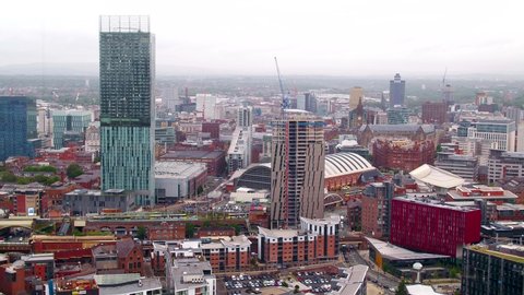 Manchester, England - August 15th 2018: Slow drifting aerial drone shot of the city of Manchester skyline and Beetham tower from the air on a grey cloudy day