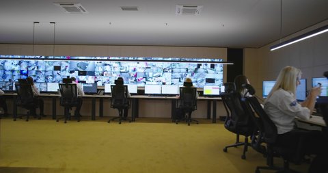 Security control room operator at work, Security System Operator Looking At Cctv Footage