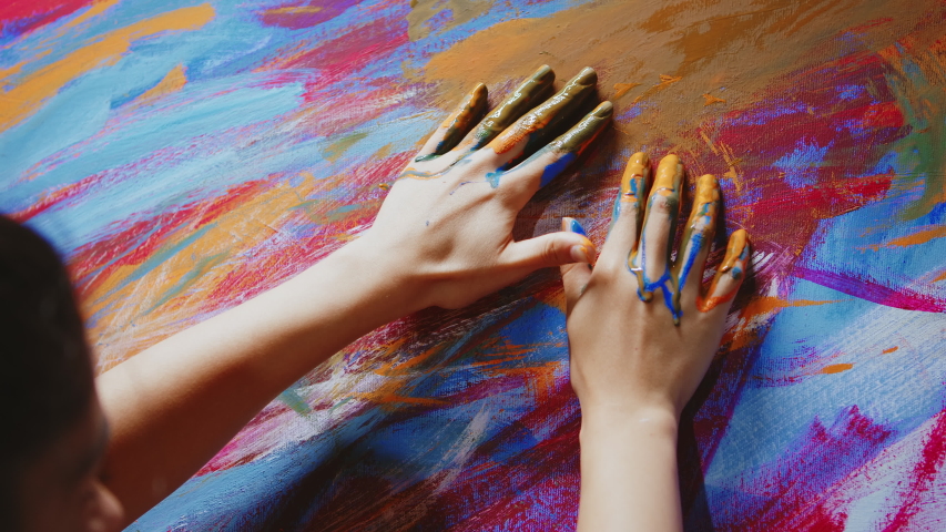 Painting with fingers technique on canvas in art workshop. Royalty-Free Stock Footage #1056398804