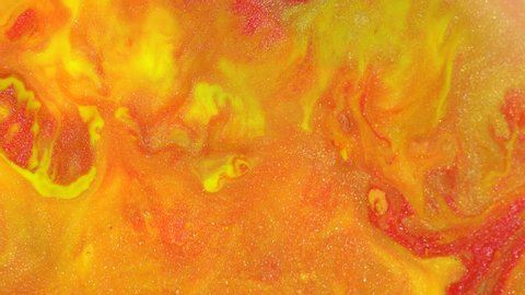 Yellow orange red colors liquid paints. Abstract Background. Acrylic Color Flowing, Liquid Acrylic Painting. Glitter texture macro