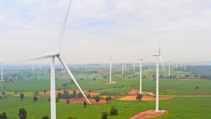 Group of wind turbines on wind farm mountain field, drone aerial view. Electricity production industry, sustainable clean energy, environment conservation, or nature power generation concept | Shutterstock HD Video #1056417533