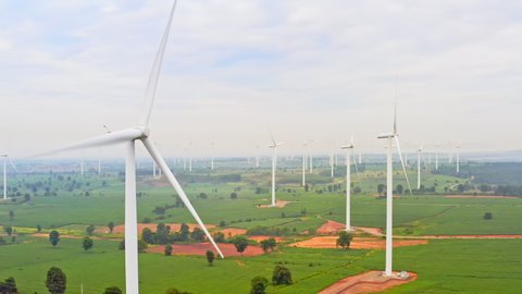Group of wind turbines on wind farm mountain field, drone aerial view. Electricity production industry, sustainable clean energy, environment conservation, or nature power generation concept