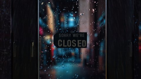 Cinematic mood shot of closed retail store shop due to coronavirus covid-19 pandemic , rainy look with raindrops on shop window