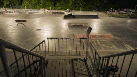 Montreal , Quebec / Canada - 06 17 2020: Wide-angle from a staircase of a skate park at night with riders doing tricks in Montreal, Quebec, Canada
