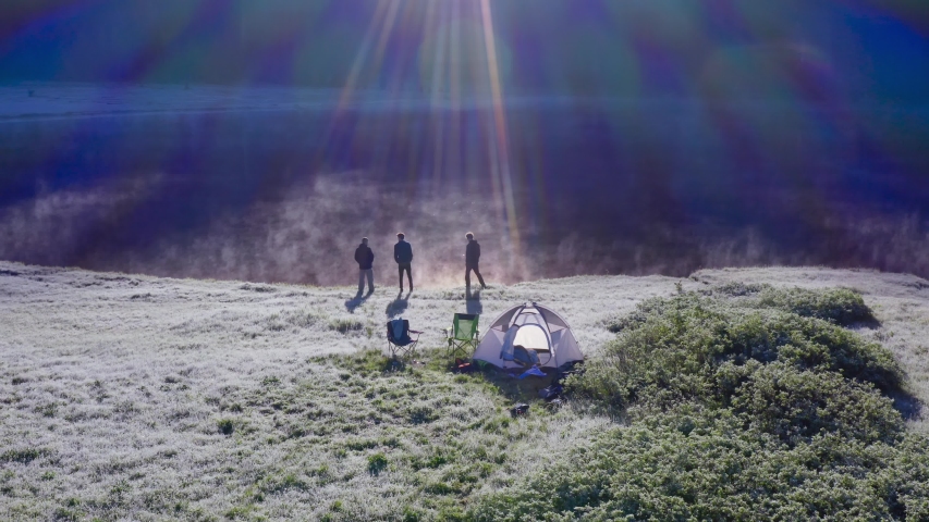 Three Campers Standing And Talking By The Shore Of Todd Lake With Rays Of Sunlight At Early In The Morning In Oregon, USA. - aerial drone