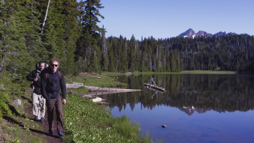 Hikers Walking On The Mountain Trail Beside Todd Lake In Oregon - dolly shot