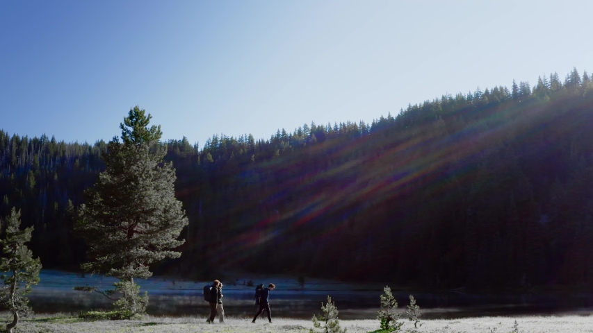 Three Hikers Hike Near The Beautiful Todd Lake In Deschutes National Forest At Sunrise In Oregon, USA - wide shot