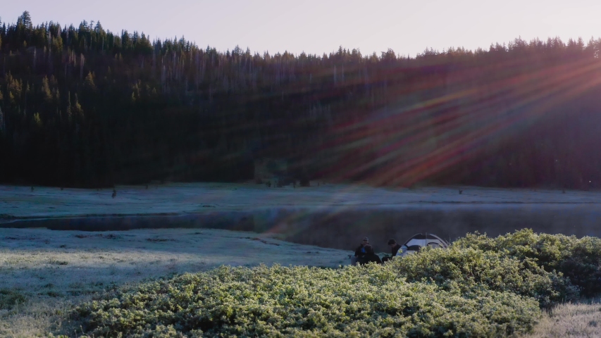 Campers Sitting At The Campsite Beside The Beautiful Todd Lake In Oregon On An Early Morning - ascending drone shot