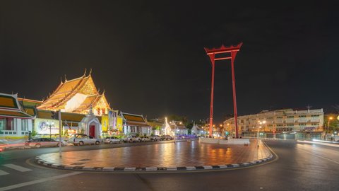 Bangkok, Thailand - 07/25/2020 : Time lapse. The Giant Swing or Sao Ching Cha monument with Wat Suthat temple at night in old town, Bangkok City, Thailand. Landmark tourist attraction.