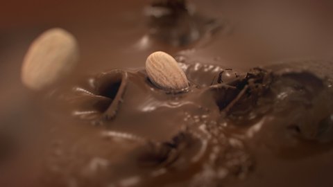 Almonds Nuts Falling Into Liquid Chocolate in 4K Super slow motion