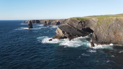 Aerial view over the Kilkee Cliffs. Beautiful rugged coast line with spectacular sea stacks. The natural beauty of the cliff edge and blue Atlantic ocean. Wild Atlantic way.