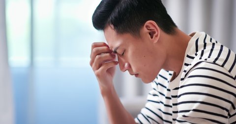 Closeup of asian man feel depressed and sitting at home