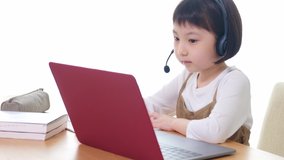 Asian little girl taking an online class. e-learning. EdTech.