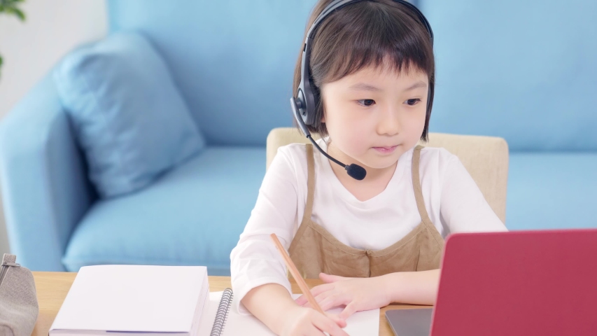Asian little girl taking an online class. e-learning. EdTech. Royalty-Free Stock Footage #1056444785