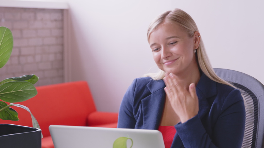 A deaf caucasian woman is making a video call and signing to relatives and friends with a laptop at home. Sign language. Technology, modern generation, family, connection, authenticity. - slow motion | Shutterstock HD Video #1056448028