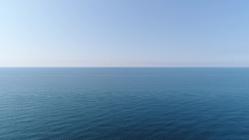 Aerial: beautiful sea background. Calm blue sea, horizon, clear sky, seascape. | Shutterstock HD Video #1056454037