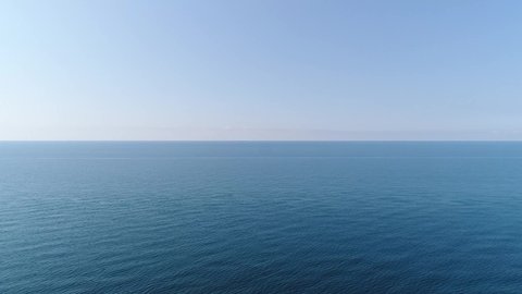 Aerial: beautiful sea background. Calm blue sea, horizon, clear sky, seascape.