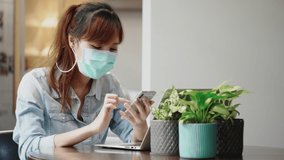 Asian businesswoman wear mask while meeting in office. Using video call laptop or smartphone With colleagues. Prevent bacteria or Coronavirus spread. Health care at work. Concept Social distancing