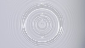 Top view of drop falls into water and diverging circles of water on white background in slow motion - Powered by Shutterstock - Get 15% off with code: PIKWIZARD15