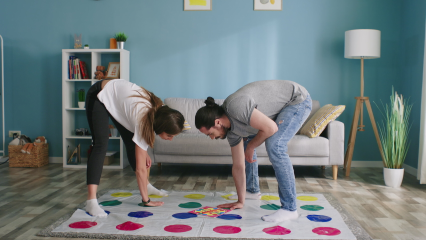 Young happy couple, man and woman, play active funny game at home, spend time together in positive mood, enjoy their weekend, Slow motion. Royalty-Free Stock Footage #1056468551
