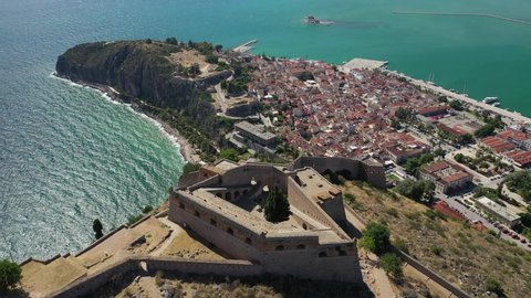 Aerial drone rotational video of historic and picturesque seaside old town of Nafplio and Acronafplia as seen from Palamidi castle, Argolida, Peloponnese, Greece