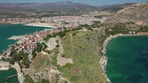 Aerial drone video of famous castle and beach of Arvanitia in the slopes of Acronafplia, Nafplio, Argolida, Peloponnese, Greece