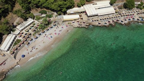 Aerial drone video of famous beach of Arvanitia in the slopes of Acronafplia, Nafplio, Argolida, Peloponnese, Greece