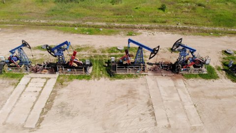Oil Drilling Derricks Oilfield Aerial View For Fossil Fuels Output and Crude Oil Production From Ground. Aerial View Oil drill rig and pump jack, industrial equipment.
