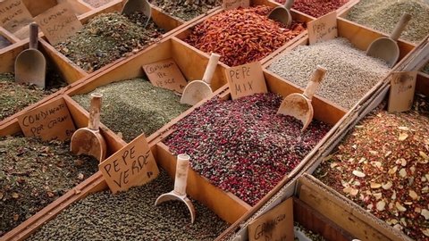 Wide variety of typical italian spices, displayed in a street market stall in Sicily, Italy. Steadicam shot