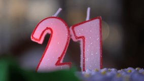 Glitter white Candles 21 Birthday cake. Numbers twenty one. Bokeh shape out of focus bg. Dolly move isolated close up. - Powered by Shutterstock - Get 15% off with code: PIKWIZARD15