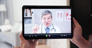 Telemedicine concept - Asian elder doctor is online to have video chat though tablet pc with patient at home