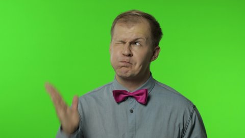 Surprised funny comical man making silly face with inflates the cheeks and looking with shocked dumb idiotic expression, grimace, fooling around. Portrait of guy posing on chroma key background