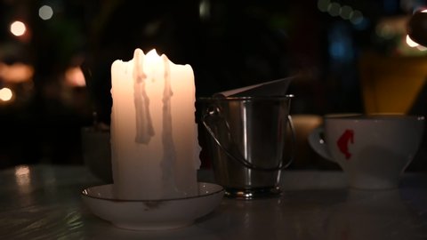 candle blazing on the table on the stand close-up video 4k