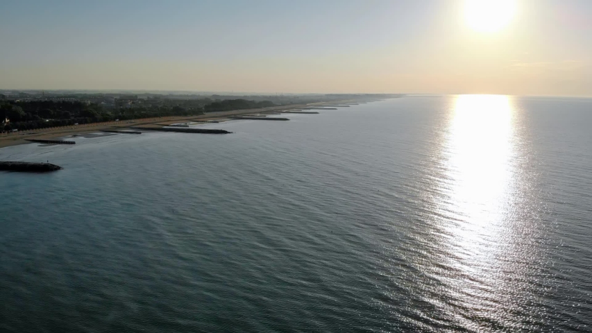 Aerial shot of a peaceful scene after sunrise on the coast of Caorle near Venice, Italy