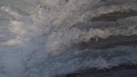 Slow motion footage of pink salmon jumping up a waterfall.